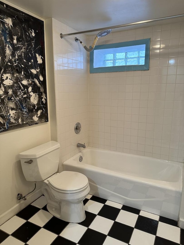 bathroom featuring toilet, shower / tub combination, baseboards, and tile patterned floors