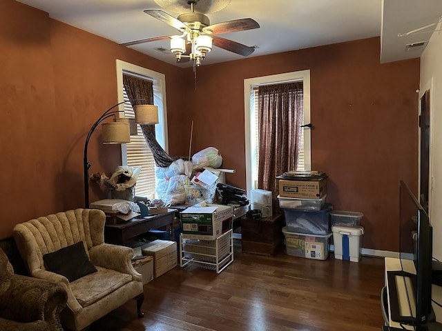 interior space with visible vents, dark wood finished floors, and ceiling fan