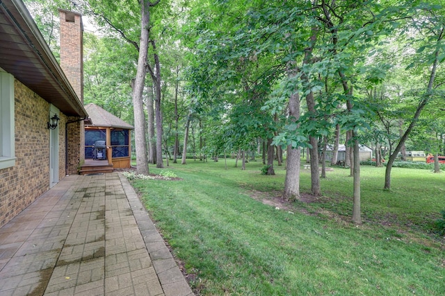 view of yard featuring a sunroom