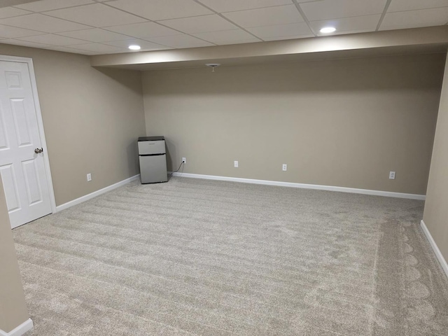 finished below grade area with carpet floors, recessed lighting, a paneled ceiling, and baseboards