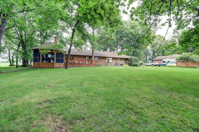 view of yard featuring a sunroom