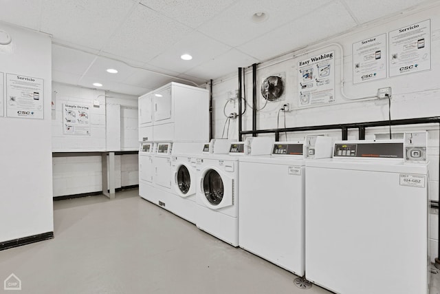 shared laundry area with washing machine and dryer, stacked washer / dryer, and recessed lighting