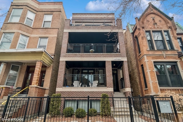 view of front of house featuring a fenced front yard and brick siding