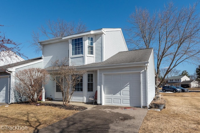 traditional-style home with an attached garage, a shingled roof, and aphalt driveway