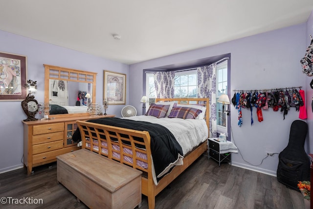 bedroom featuring baseboards and wood finished floors