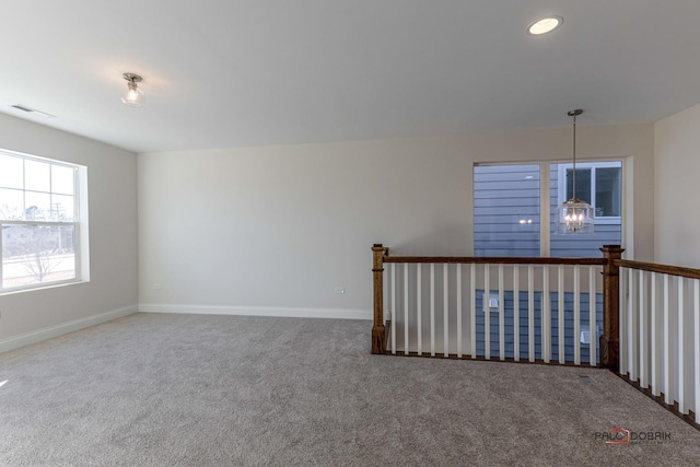 empty room featuring carpet floors, visible vents, baseboards, and recessed lighting