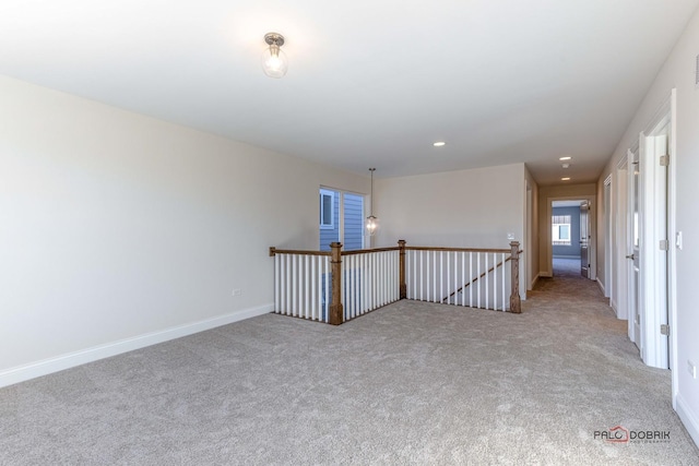 carpeted empty room featuring baseboards and recessed lighting