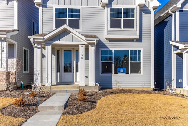 doorway to property featuring board and batten siding