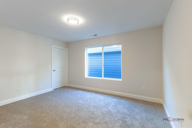 carpeted empty room with baseboards and visible vents