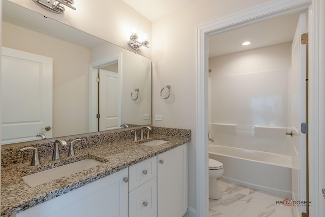 full bathroom with shower / washtub combination, a sink, toilet, and double vanity