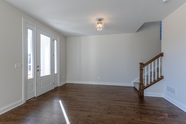 entrance foyer featuring dark wood-style floors, stairway, visible vents, and baseboards