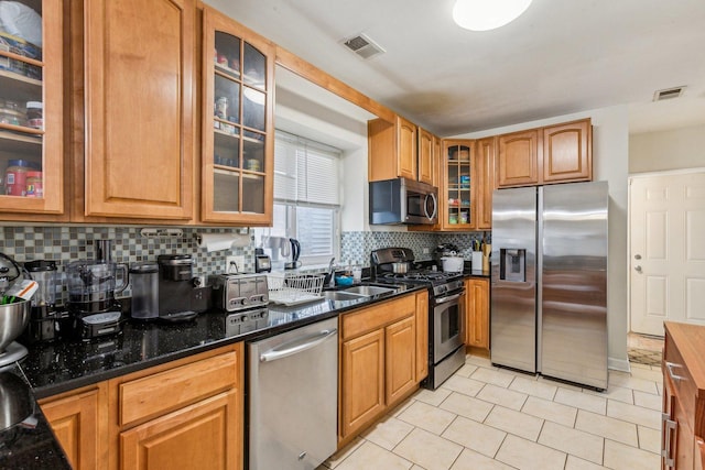 kitchen featuring visible vents, appliances with stainless steel finishes, backsplash, and a sink