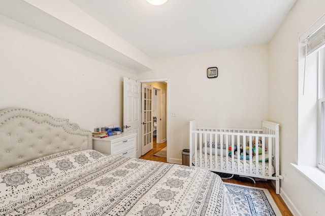 bedroom featuring baseboards and wood finished floors