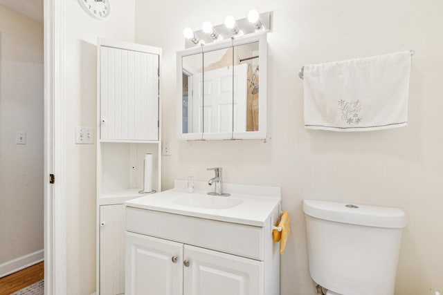 bathroom with toilet and vanity