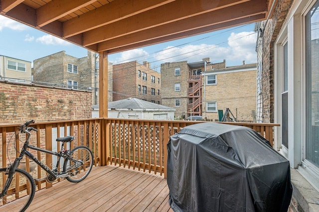 wooden terrace featuring area for grilling