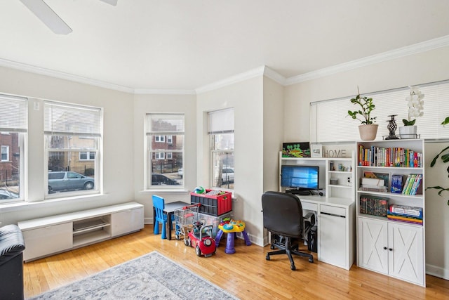 office space featuring crown molding, baseboards, and wood finished floors