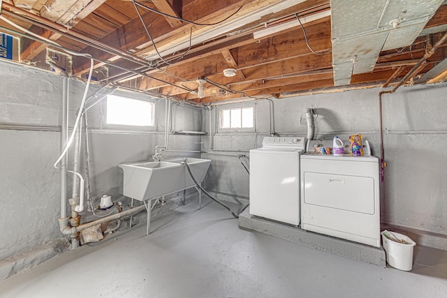 basement featuring a sink and washer and dryer