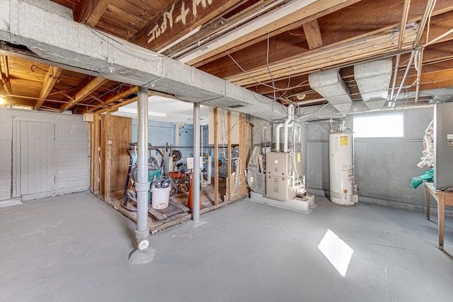 basement featuring heating unit and water heater