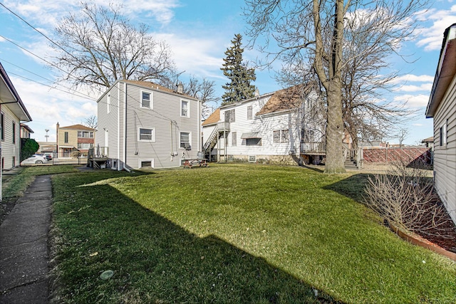 view of yard featuring a residential view, fence, and stairs