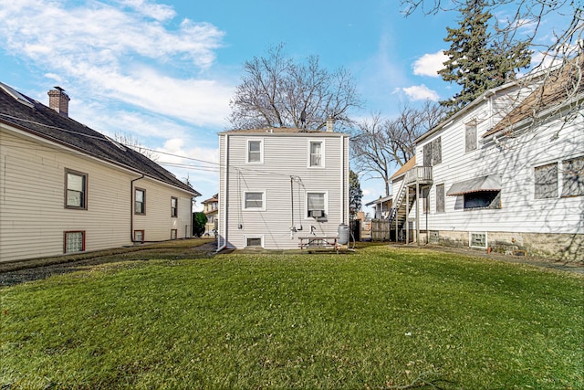 rear view of property featuring a yard