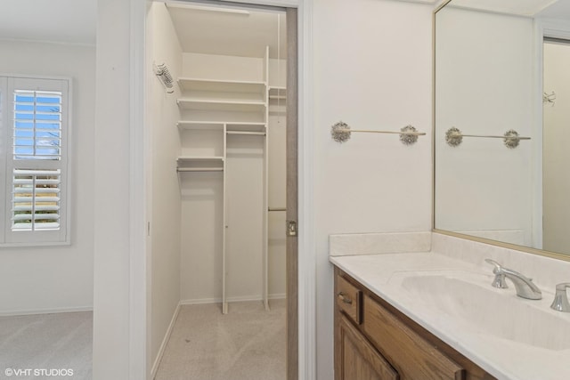 bathroom with baseboards and vanity