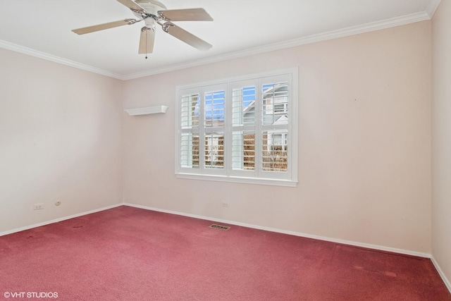 carpeted spare room with baseboards, visible vents, ceiling fan, and crown molding