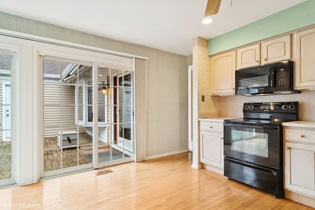 kitchen featuring a ceiling fan, light countertops, light wood-style flooring, and black appliances