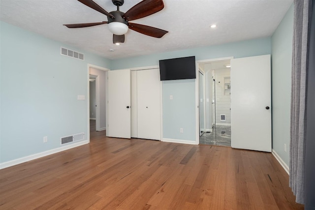 unfurnished bedroom with light wood-type flooring, visible vents, and baseboards