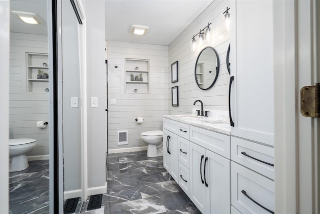 bathroom with visible vents, toilet, marble finish floor, vanity, and wood walls