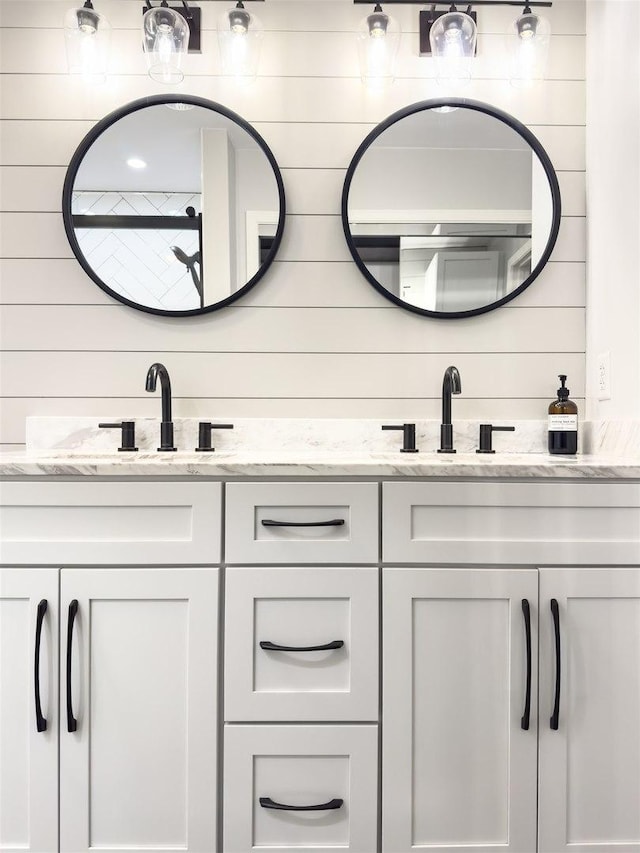 full bathroom featuring double vanity and a sink