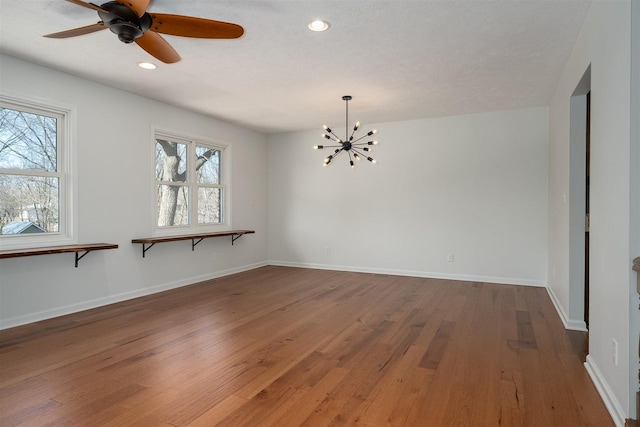 unfurnished room with plenty of natural light, baseboards, and hardwood / wood-style floors