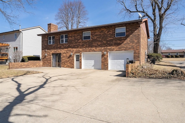 view of front of property featuring an attached garage, central air condition unit, brick siding, driveway, and a chimney