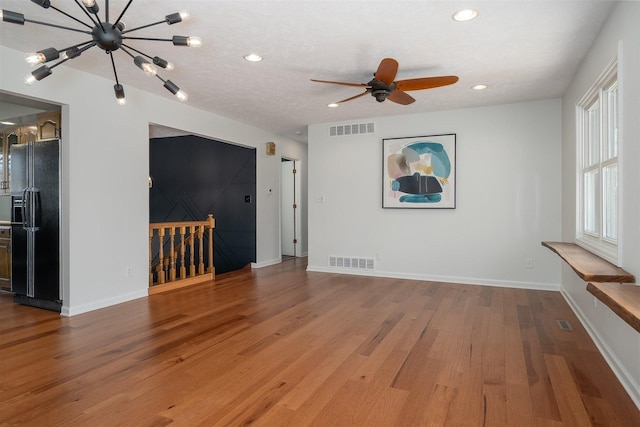 unfurnished room featuring recessed lighting, visible vents, baseboards, and wood finished floors