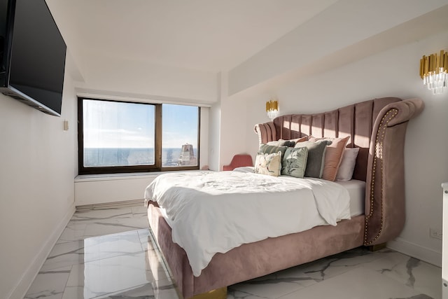 bedroom featuring marble finish floor and baseboards