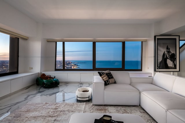 living area featuring a healthy amount of sunlight and marble finish floor