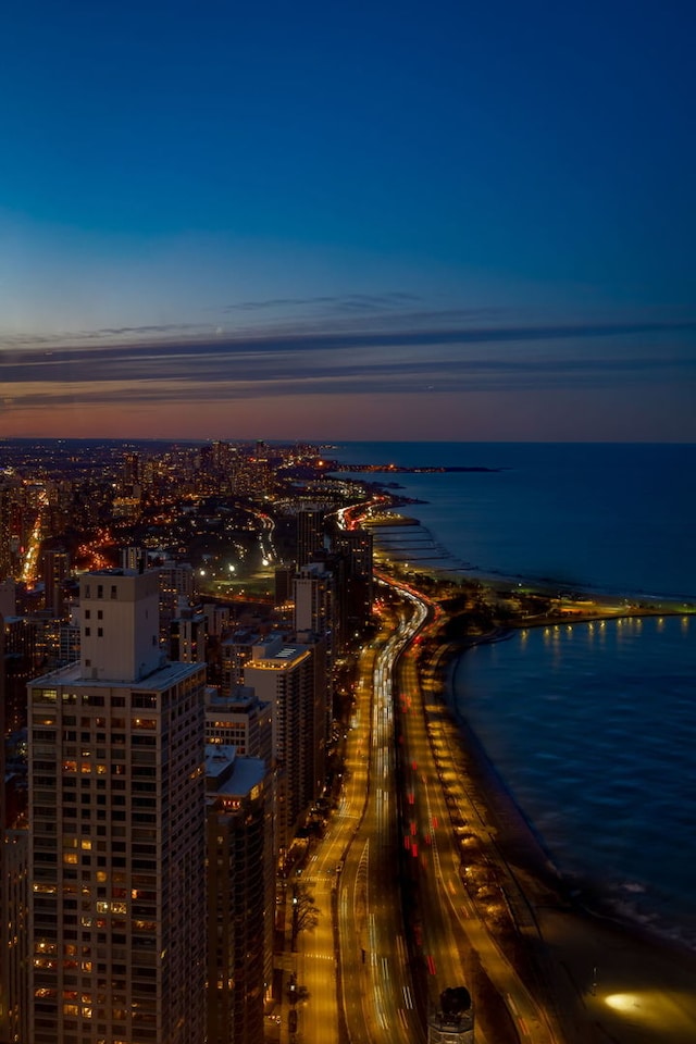 birds eye view of property featuring a city view and a water view