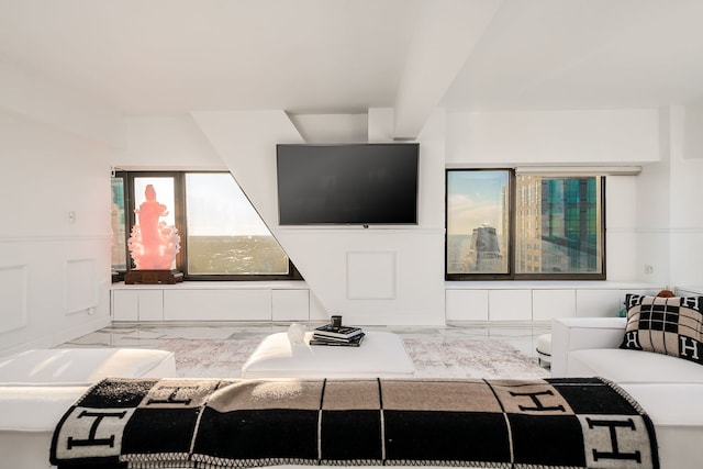 living area featuring marble finish floor