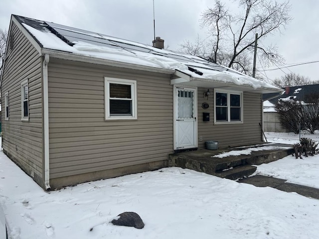 view of front facade with a garage, fence, and a chimney