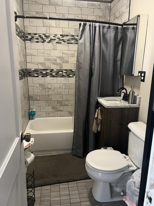 full bath featuring tile patterned floors, a sink, toilet, and shower / tub combo with curtain