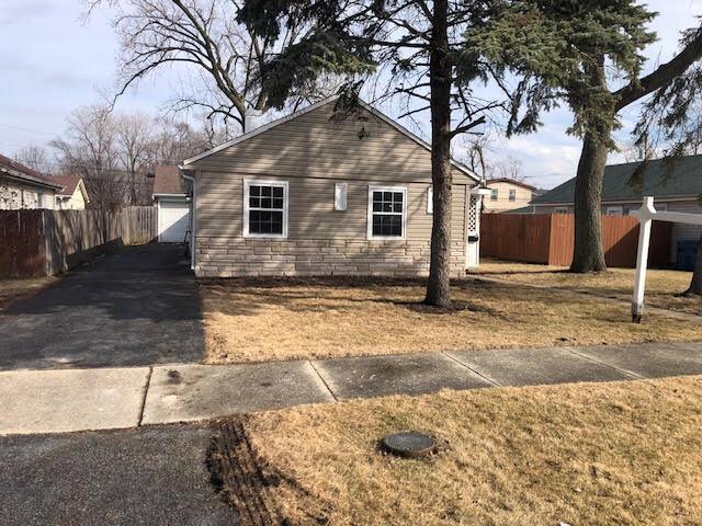 view of home's exterior featuring stone siding and fence