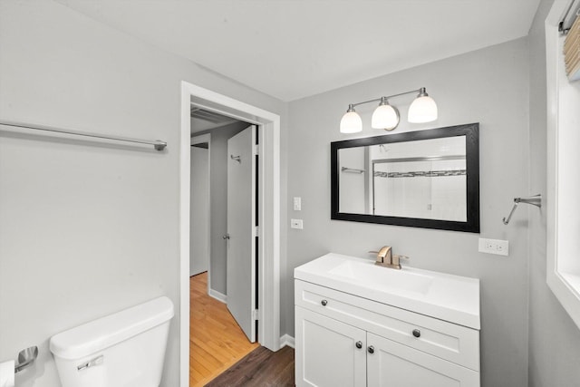 full bathroom with vanity, wood finished floors, and toilet