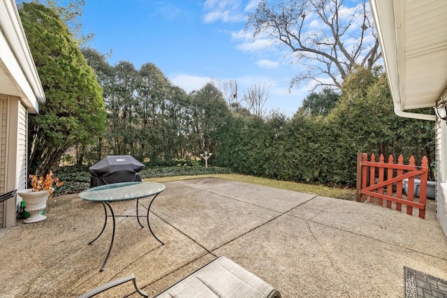 view of patio / terrace with a grill and fence