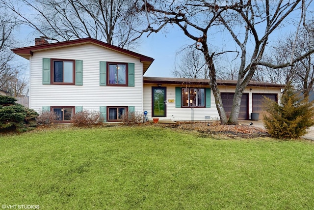 split level home with an attached garage, a chimney, and a front yard