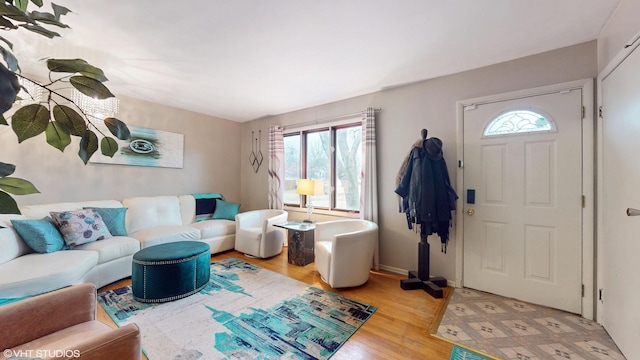 living room with baseboards and wood finished floors