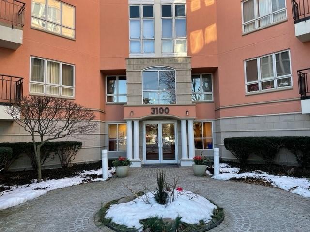 snow covered property entrance with stucco siding and french doors