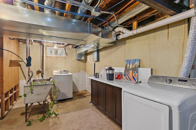 washroom with cabinet space and washer / dryer