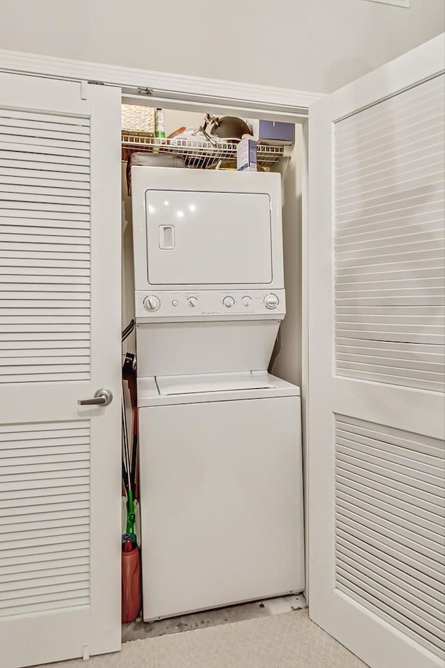 laundry area featuring laundry area and stacked washer and clothes dryer