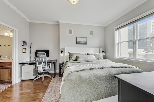 bedroom with baseboards, visible vents, dark wood-style flooring, crown molding, and a sink