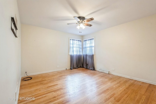 empty room featuring light wood-style floors, visible vents, baseboards, and a ceiling fan