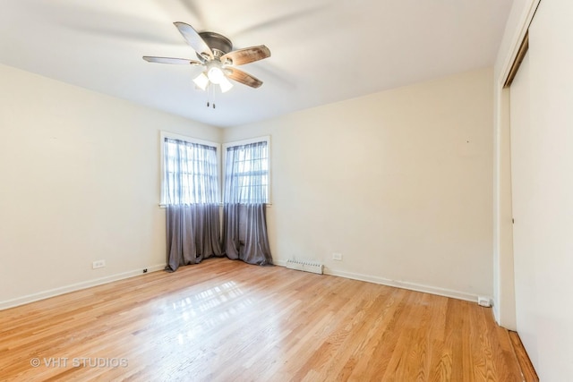 spare room with a ceiling fan, baseboards, visible vents, and light wood finished floors